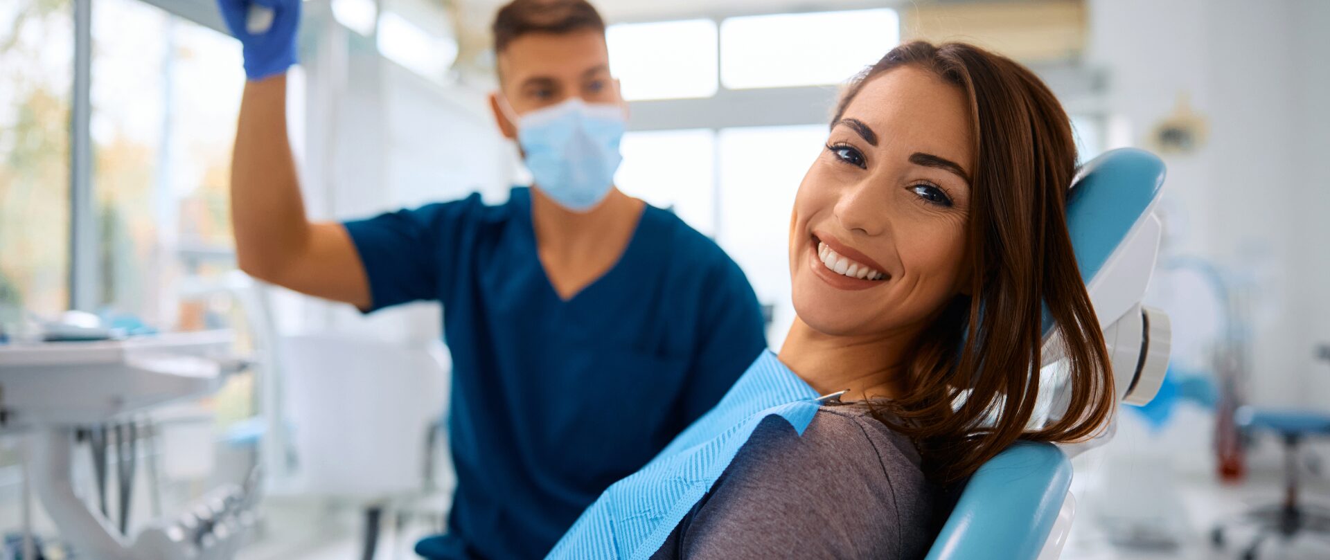 Woman smiling in dental clinic chair.