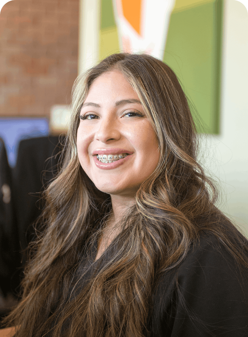 Smiling woman with long hair and braces.